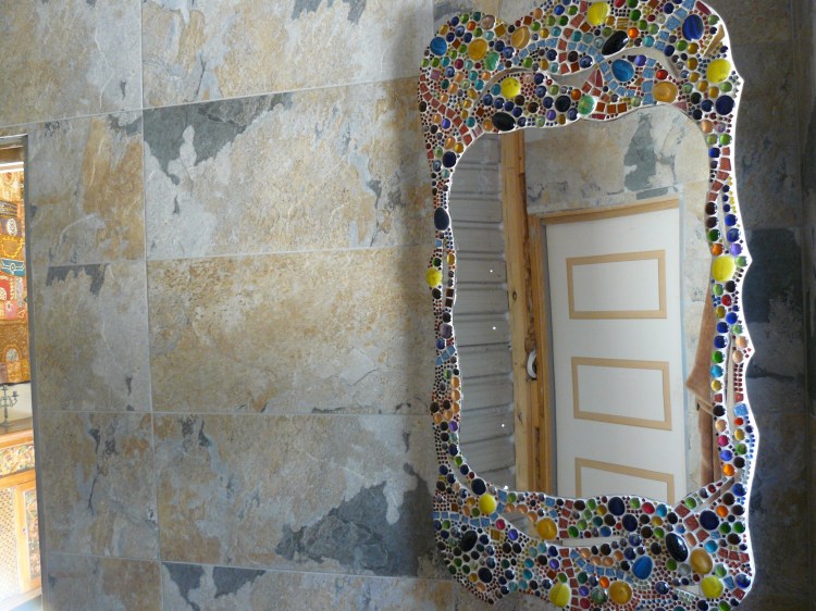 This shot shows the bathroom mirror in more detail. In behind is a cabinet that is built into the wall.